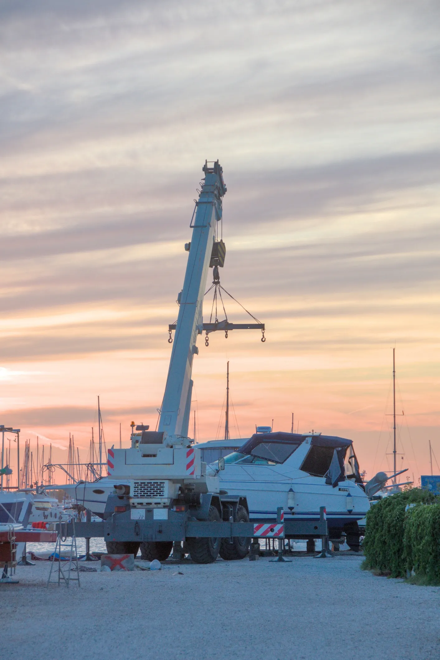Large mobile crane at sunset in Mumbai harbor